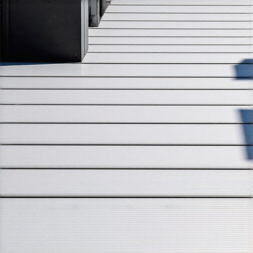 Close-up of a composite deck showing a dark charcoal fascia board with a clean overhang shadow line.